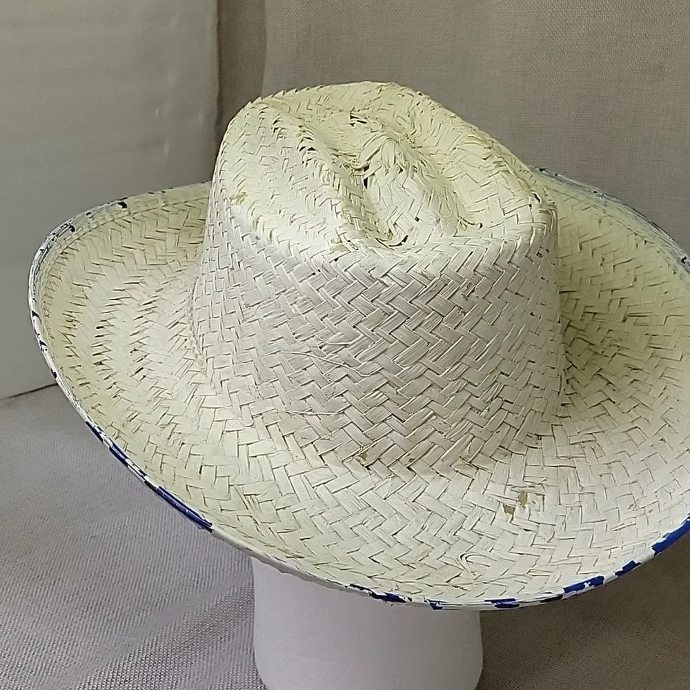 Straw‎ cowboy hat with blue trim.
